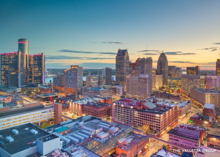 Detroit skyline at dusk with Renaissance Center and downtown skyscrapers along the Detroit River